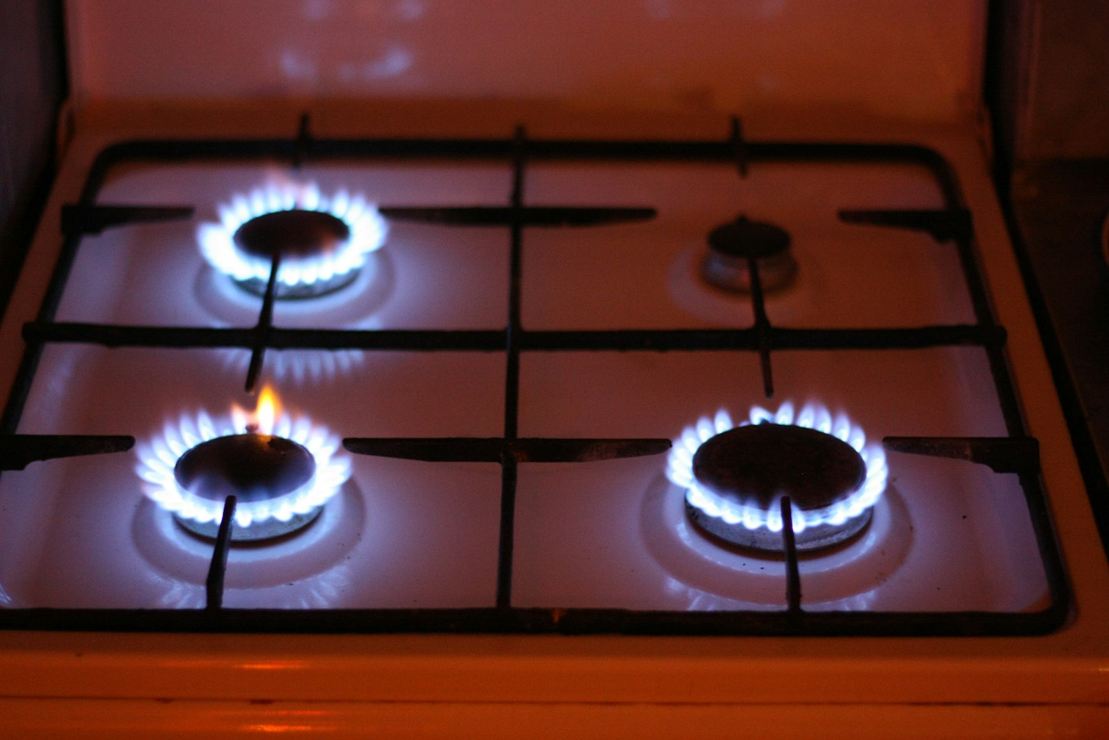 LG gas cooktop with lit blue-flame burners — professional appliance repair