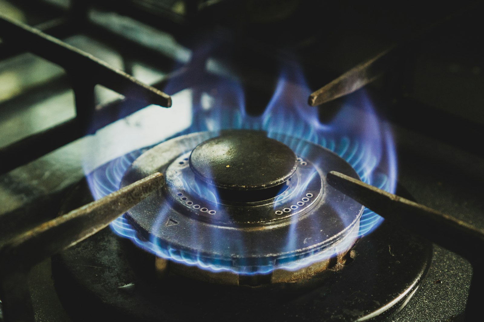 LG cooktop burner detail with blue flame — professional appliance repair