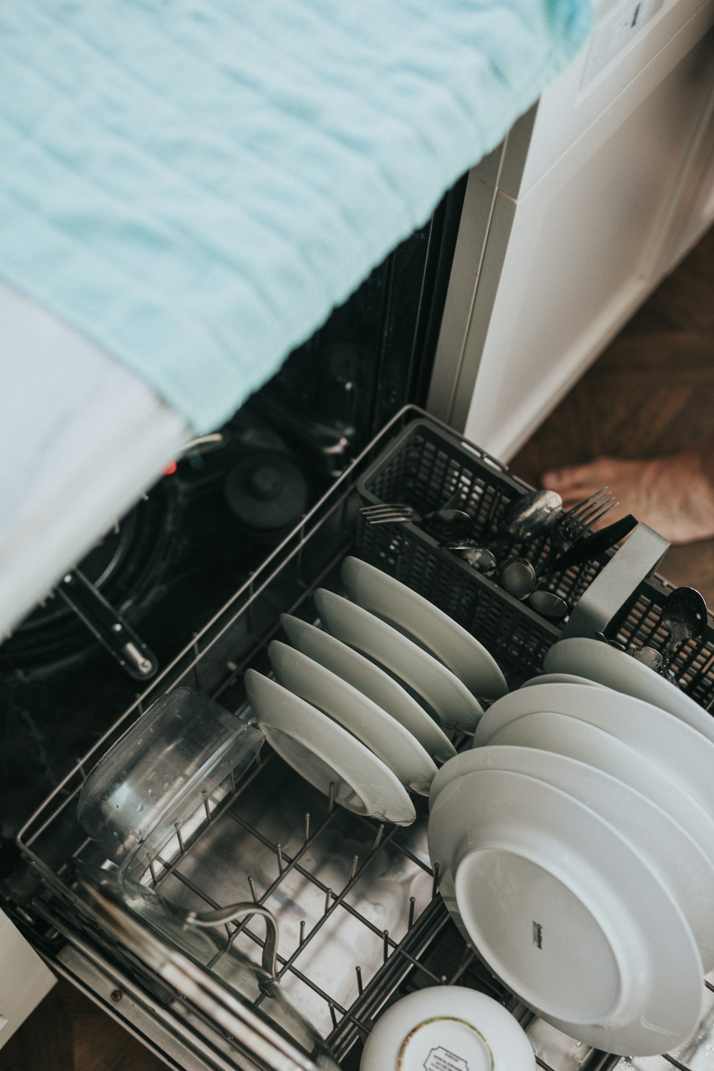 An open LG dishwasher loaded with clean dishes — professional appliance repair