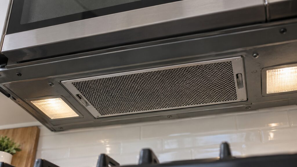 A close-up of the vent grille on the underside of an over-the-range microwave